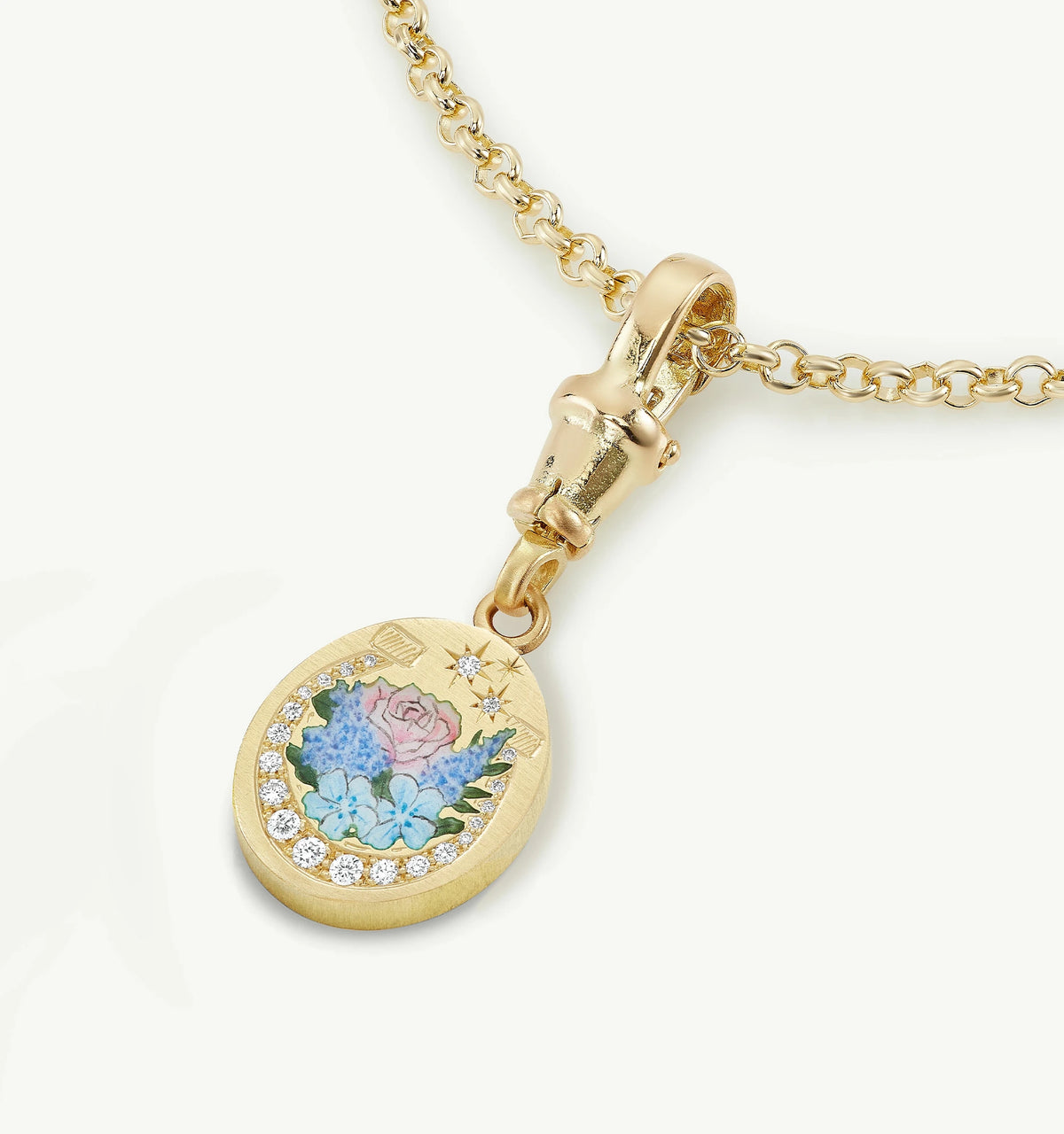 Gold pendant featuring an enamel floral design and diamonds on a delicate chain.