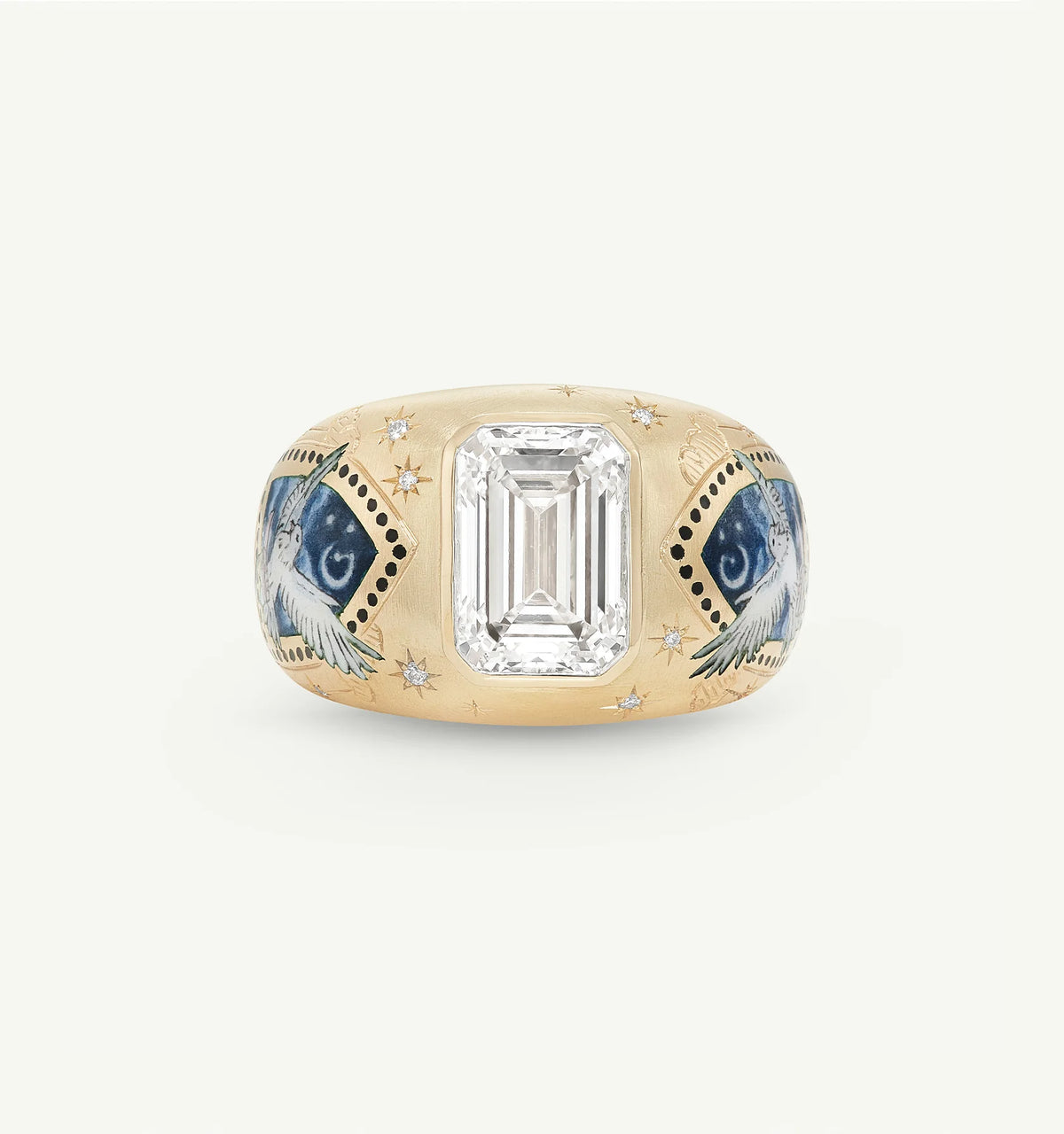Gold ring featuring an emerald-cut centre stone, detailed with painted birds and star motifs.
