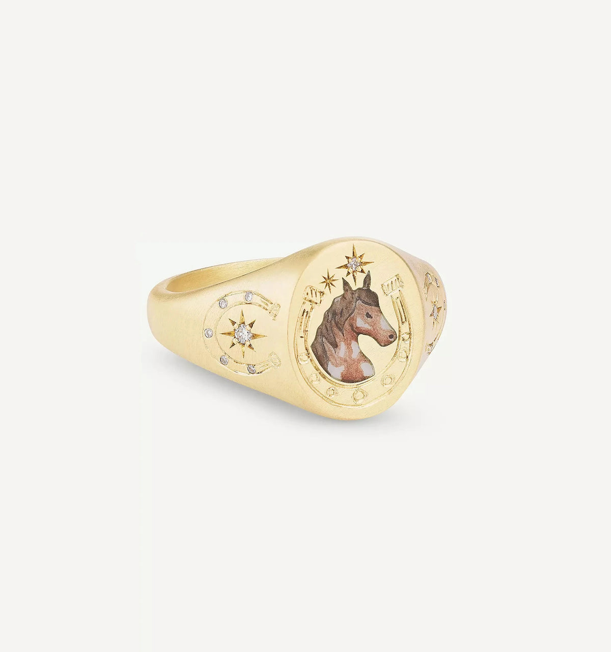 Gold signet ring featuring a painted horse design and small diamonds with star motifs.