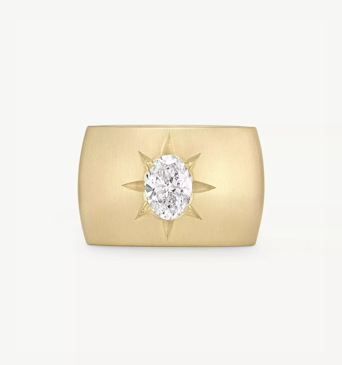 Gold ring featuring an oval diamond surrounded by a sunburst design.