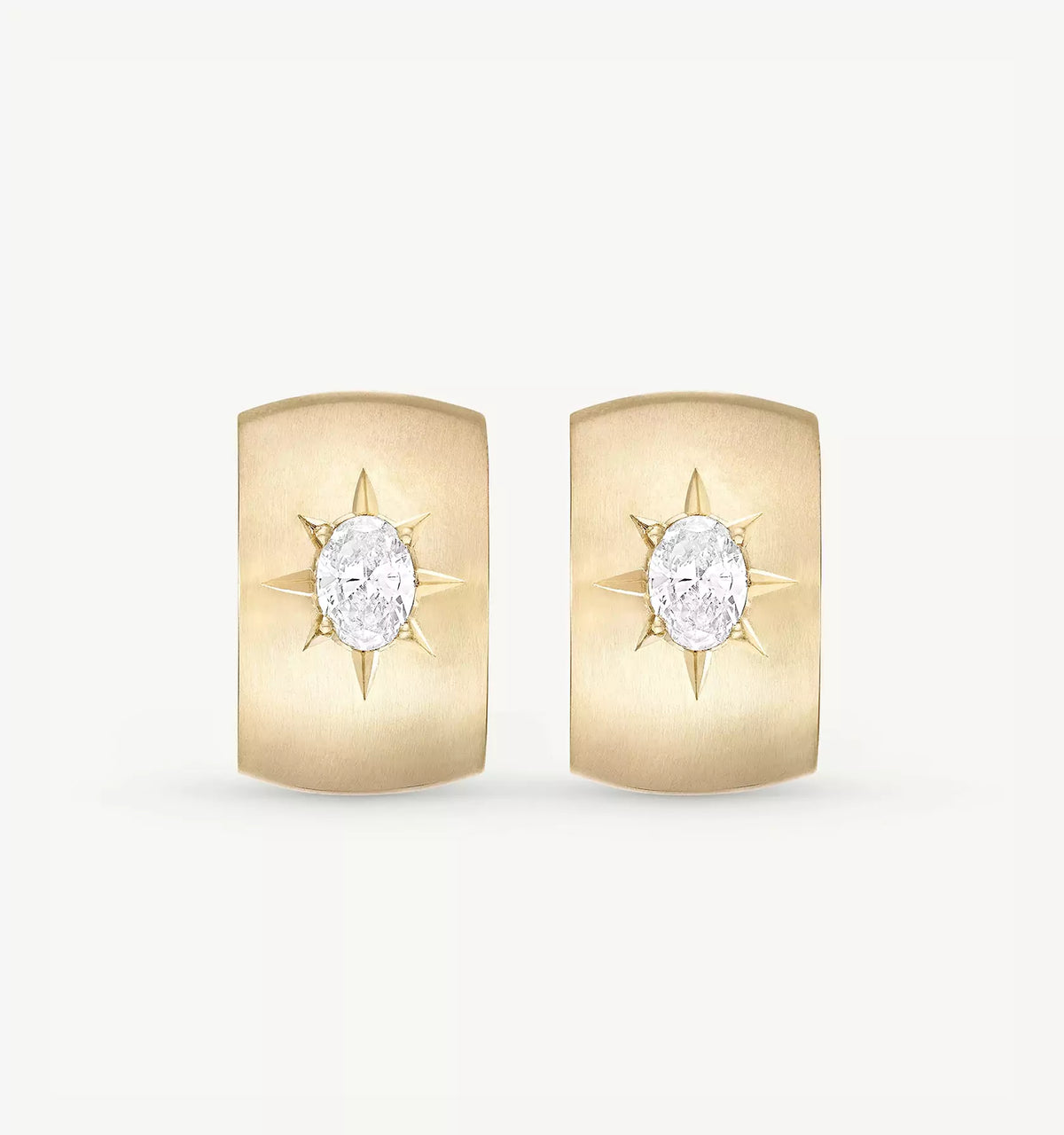 Gold earrings featuring a central oval diamond encircled by pointed gold star motifs.