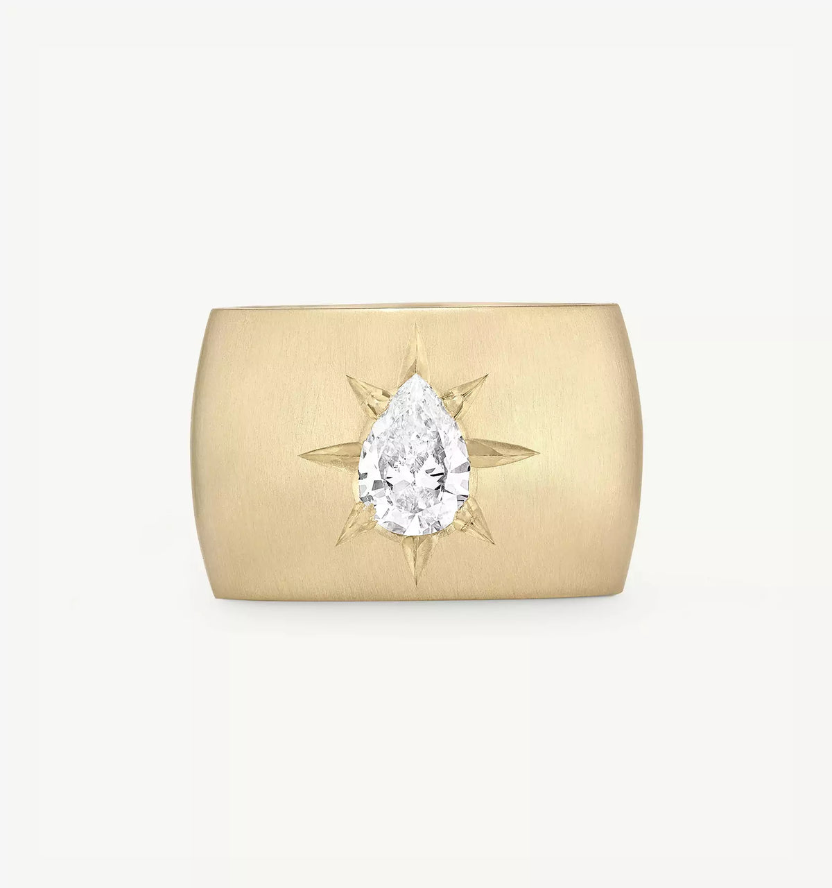 Gold ring featuring a pear-shaped diamond surrounded by angular gold accents.