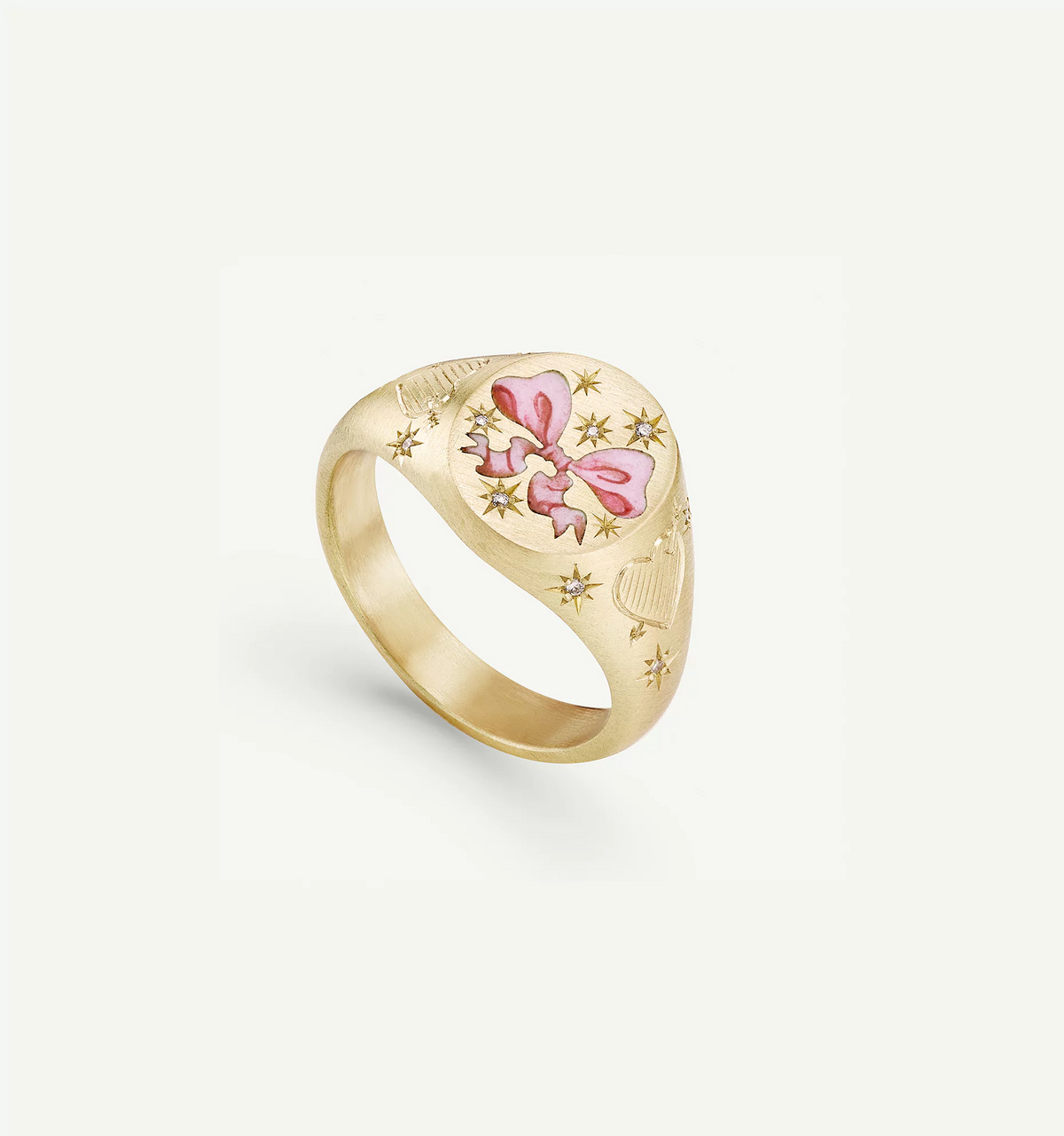 Gold ring with an engraved pink bow and star motifs, with intricate detailing in a polished finish.