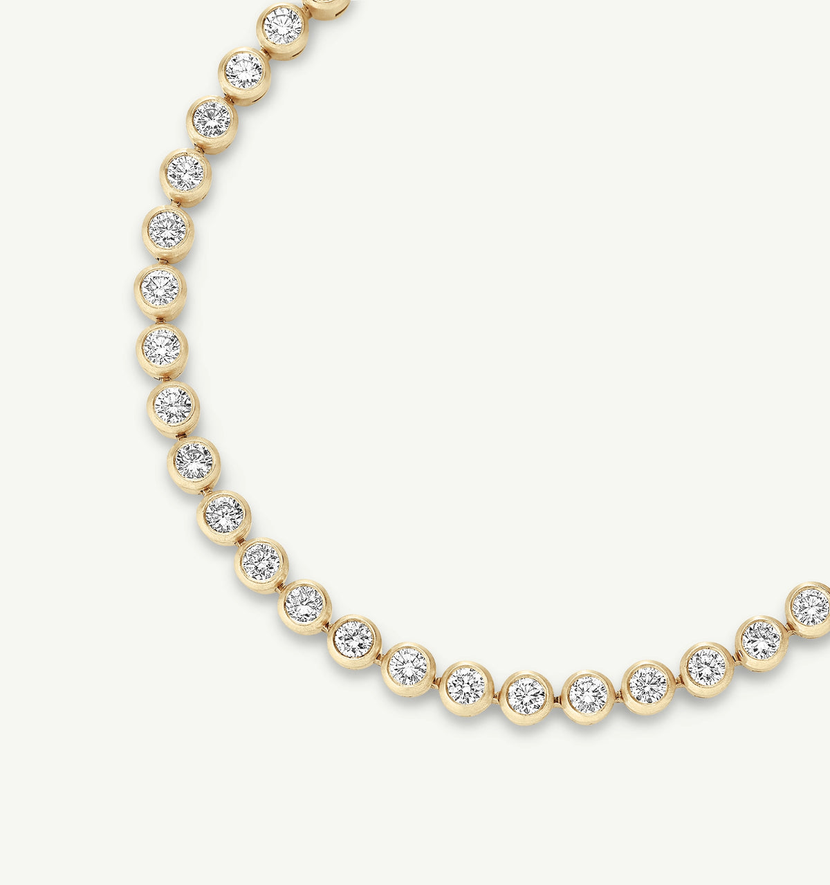 Gold necklace featuring alternating round settings with diamonds.