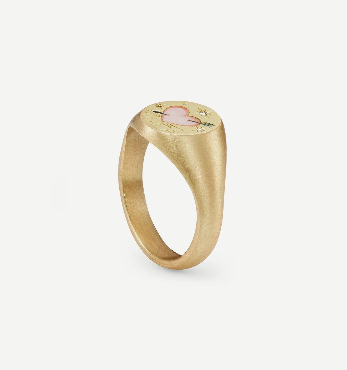 Gold ring featuring a heart and star design in enamel on the surface.