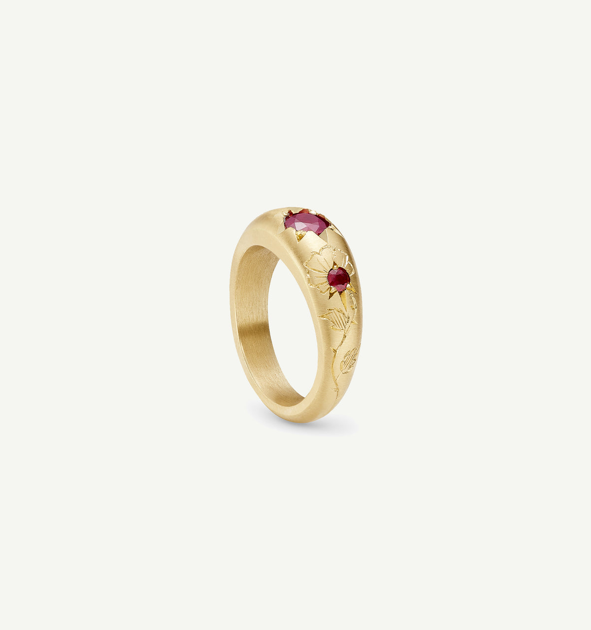 Gold ring featuring engraved floral motifs and three rubies.