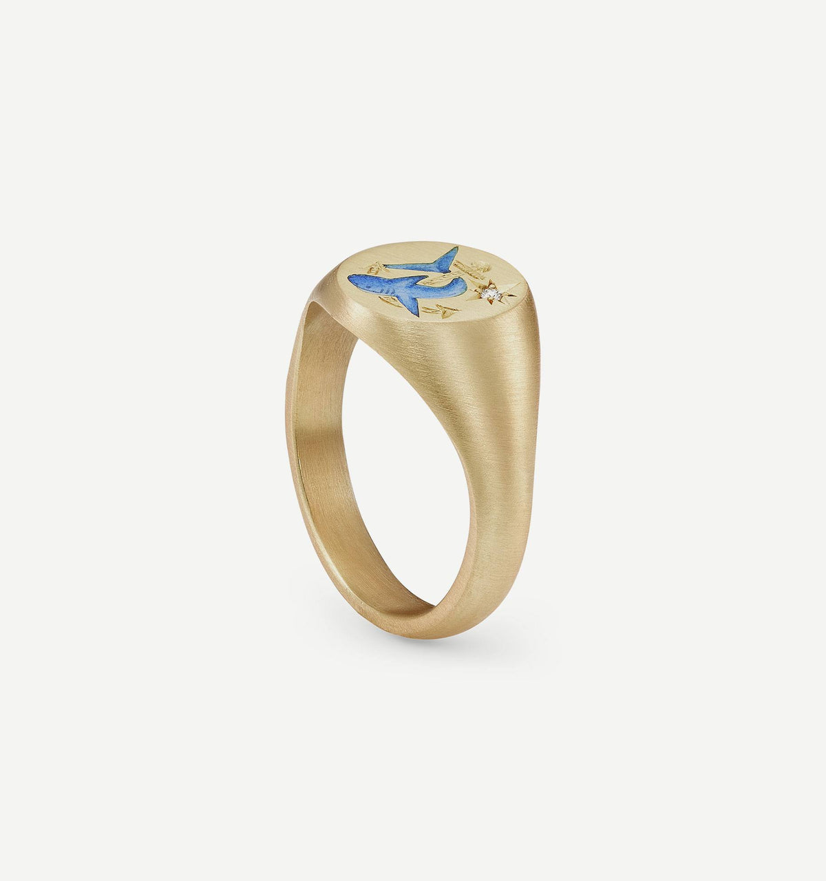 Gold ring featuring an engraved blue shark design with star motifs.