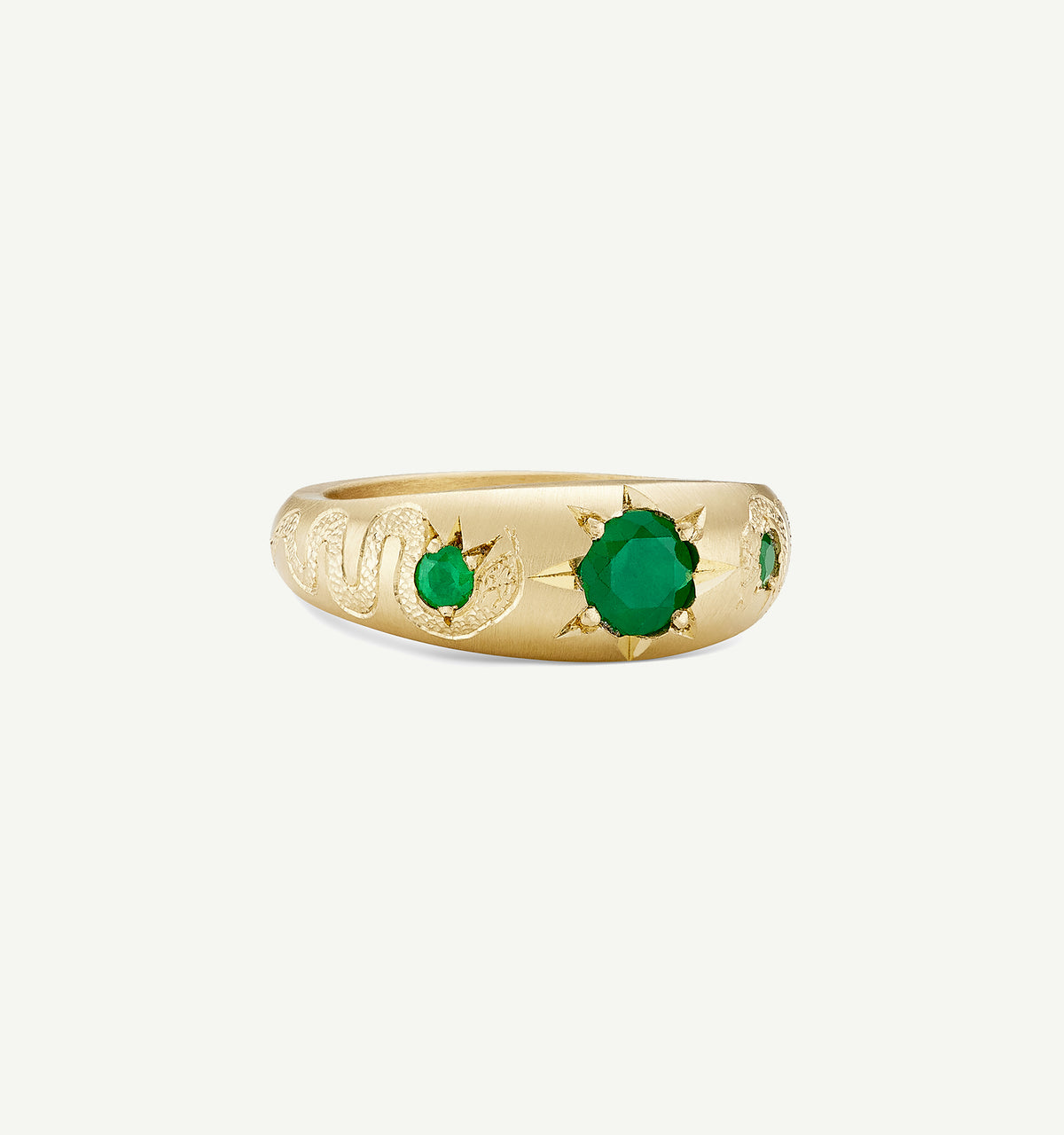 Gold ring featuring emeralds and snake and sun motifs.