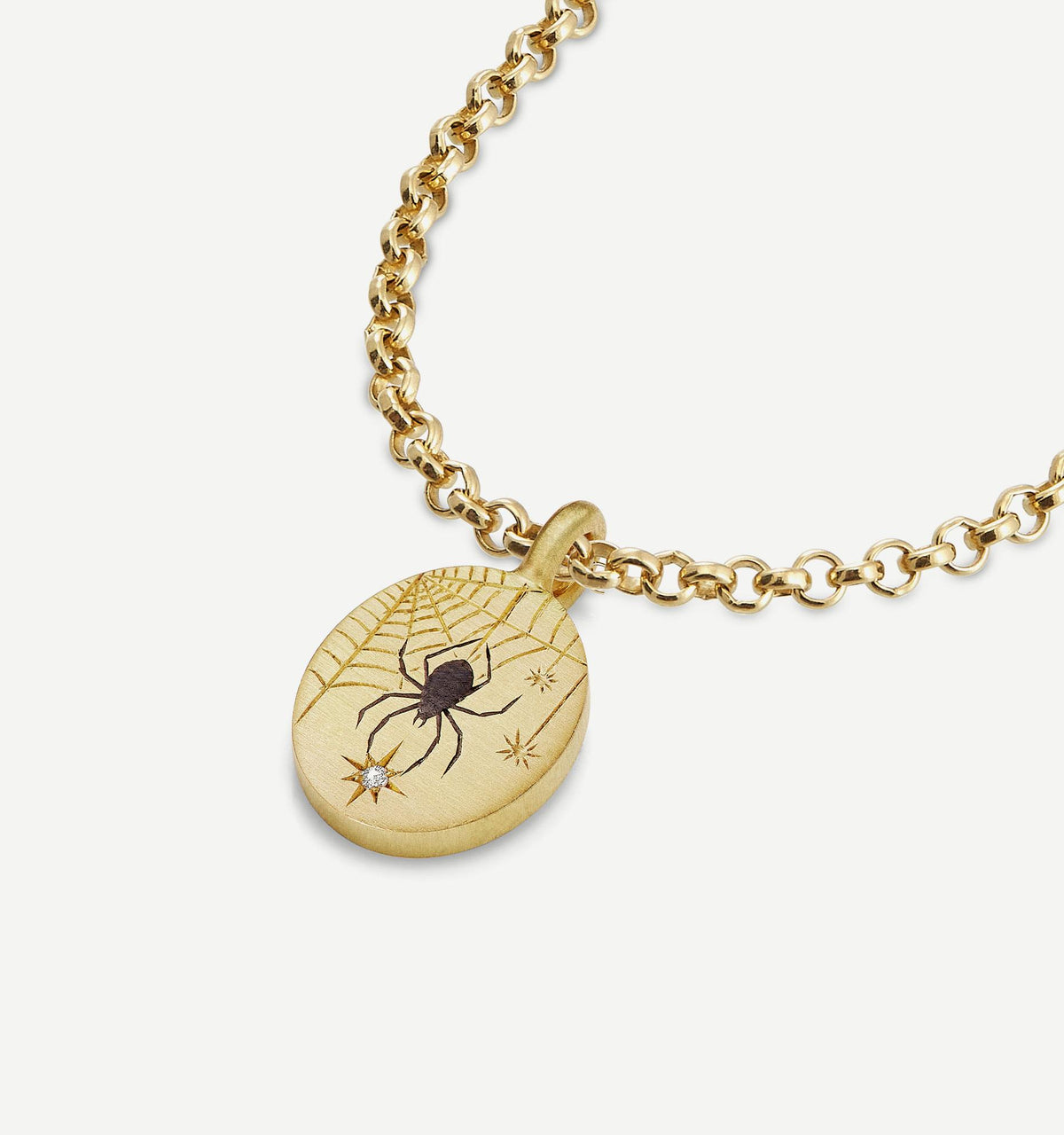 Gold pendant necklace featuring a spider design and a single diamond accent on a textured chain.